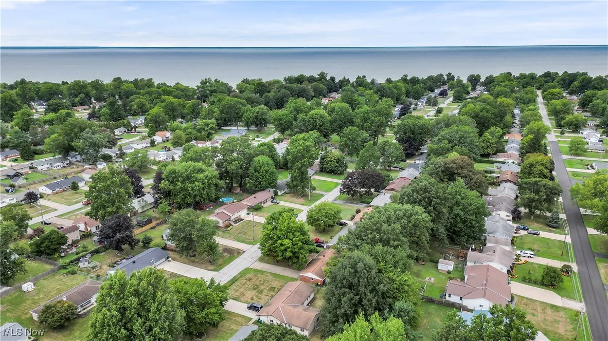 Aerial perspective of suburban area with a nearby body of water