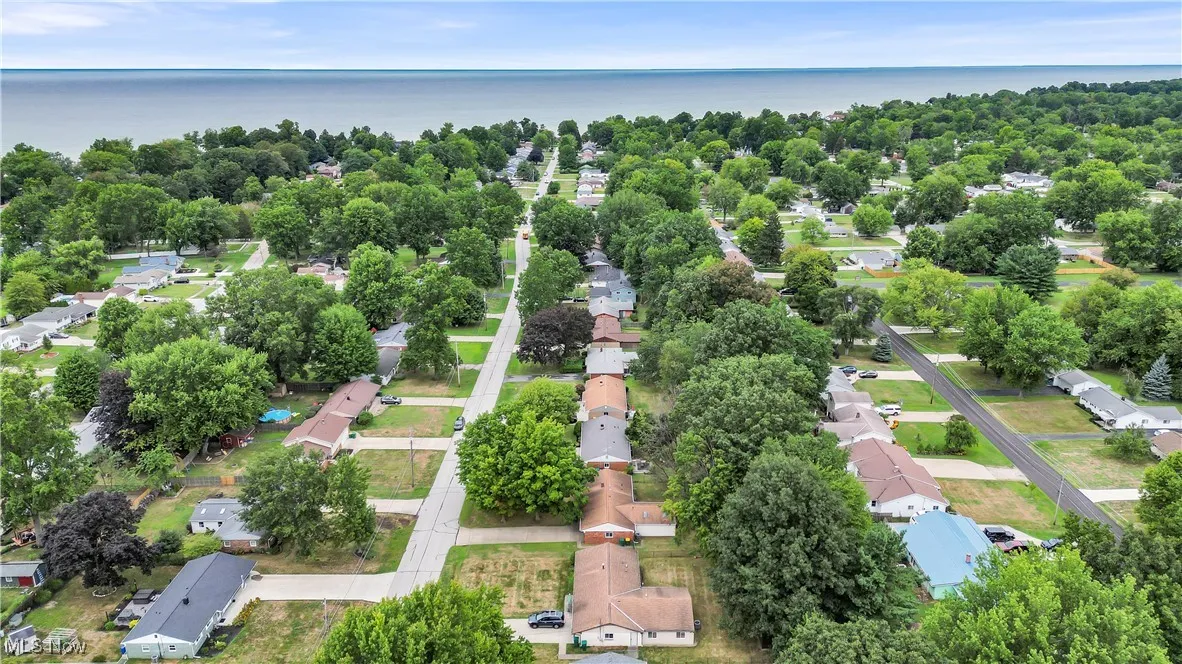 Aerial perspective of suburban area with a nearby body of water