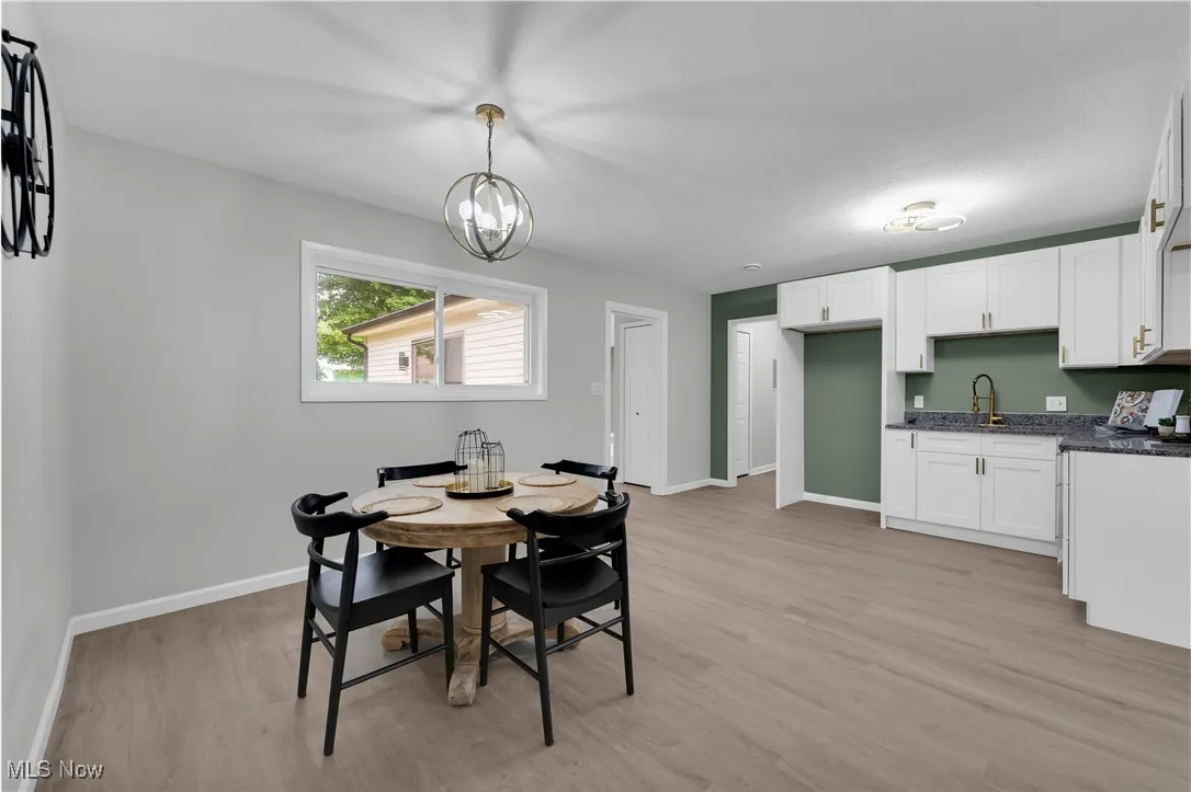 Dining room featuring light wood finished floors and a chandelier