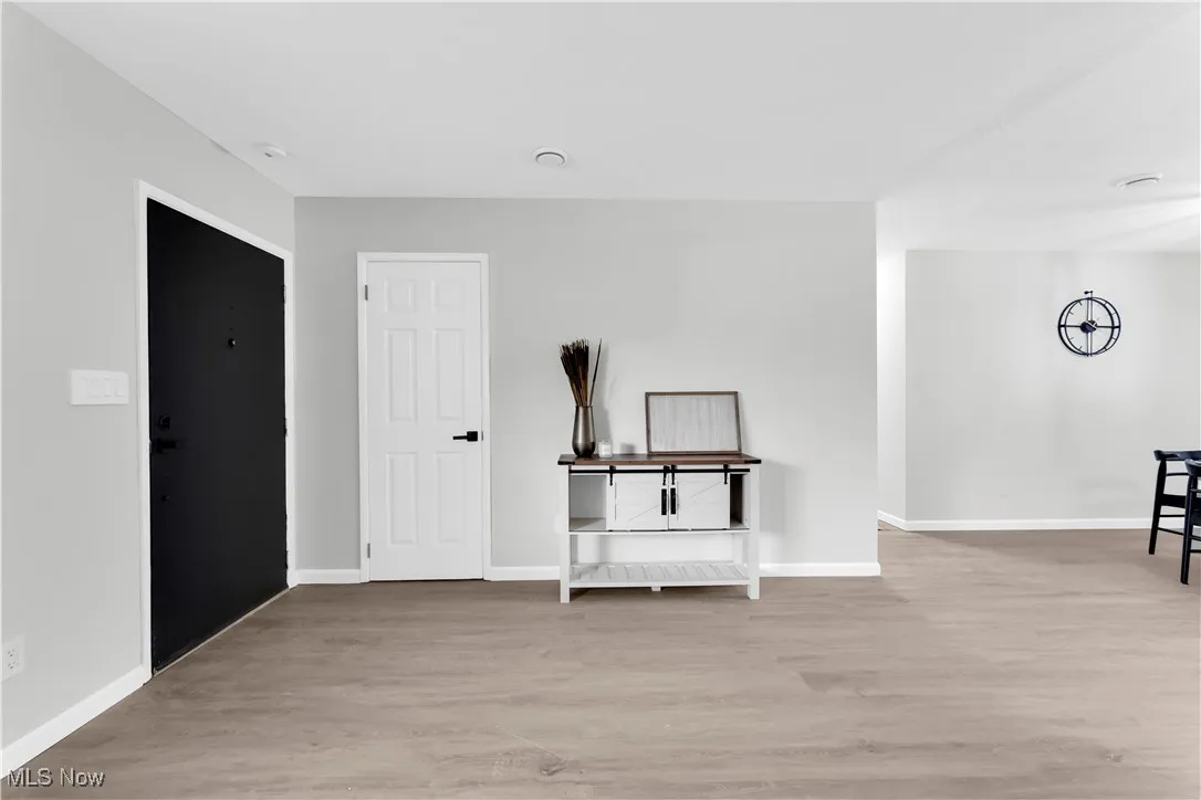 Spare room featuring light wood finished floors and baseboards