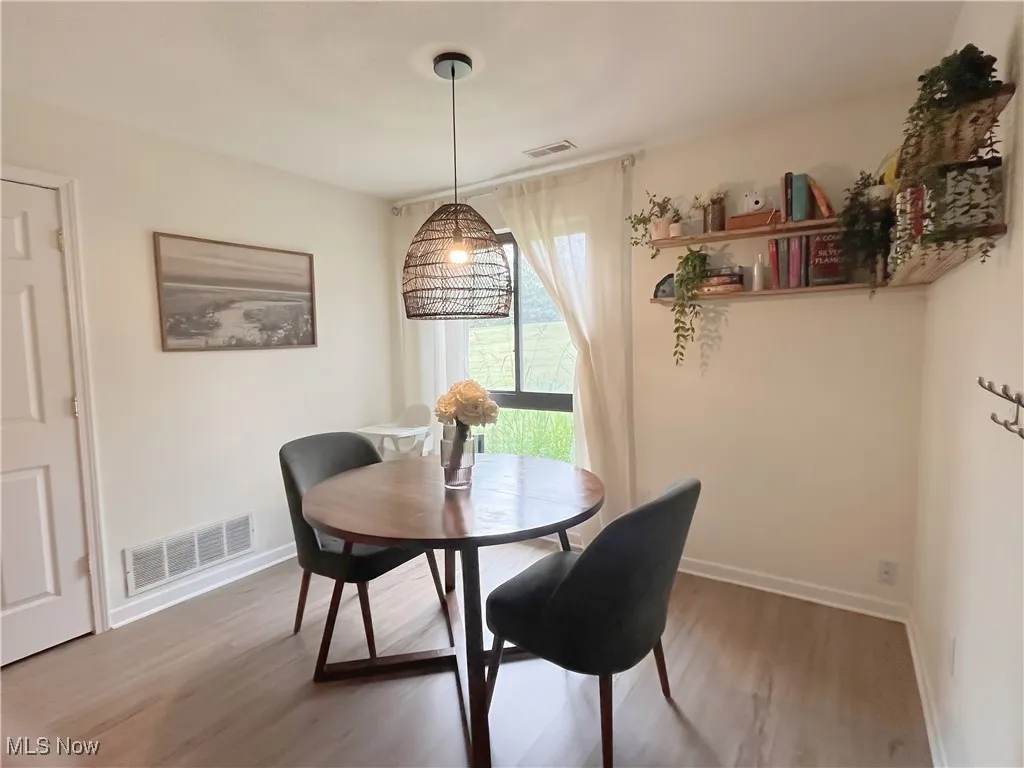 Dining space featuring wood finished floors and baseboards
