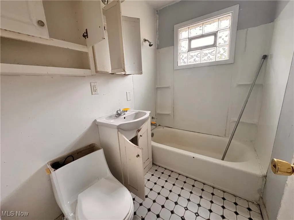 Full bath with bathing tub / shower combination, vanity, and light flooring