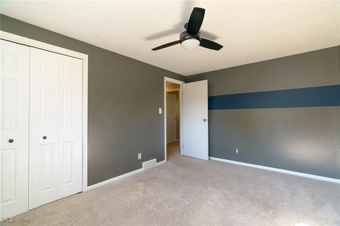 Bedroom #2 with carpet flooring, a closet, and ceiling fan