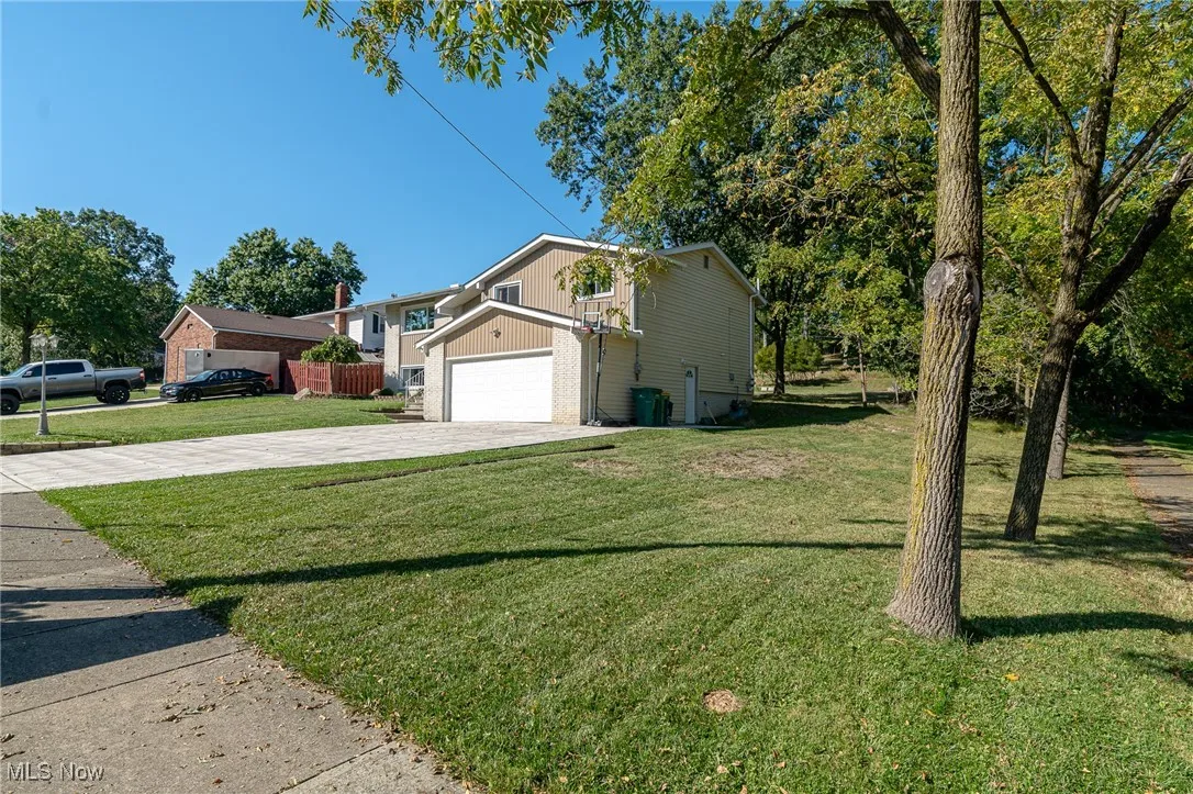 View of side of home with a garage and driveway