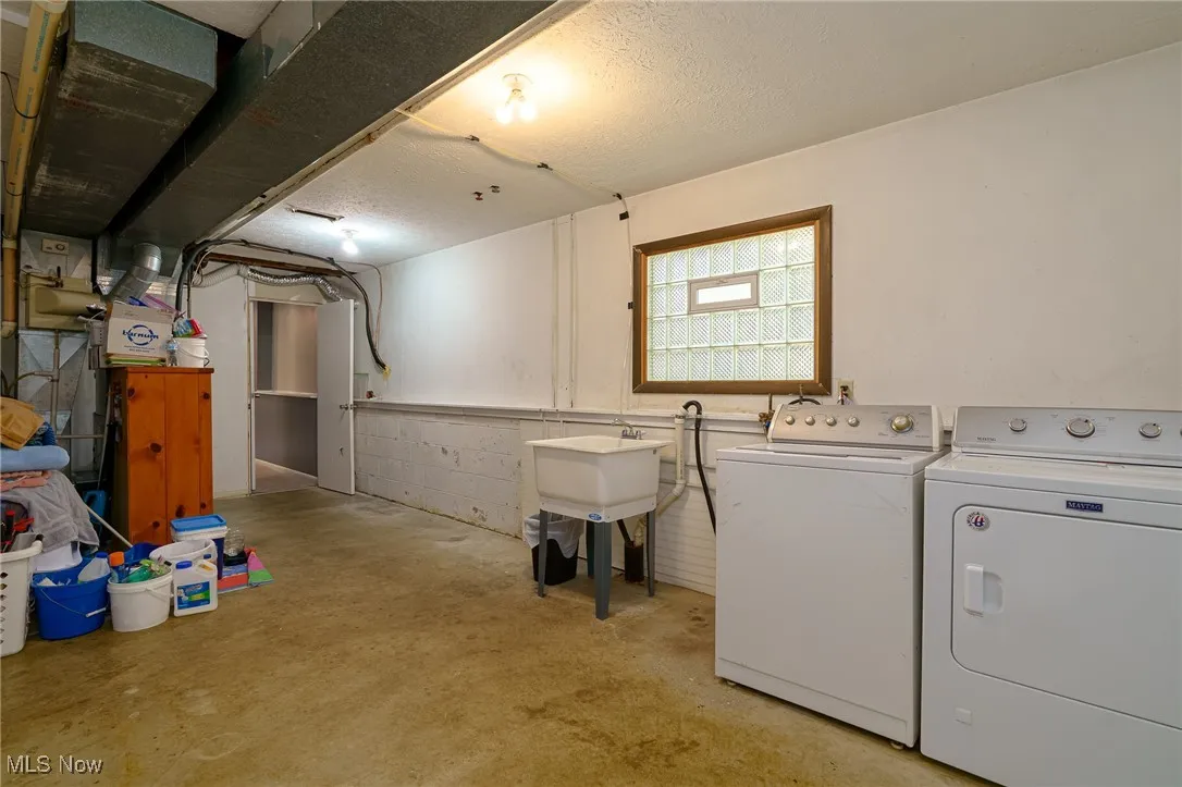 Basement with a laundry area and storage