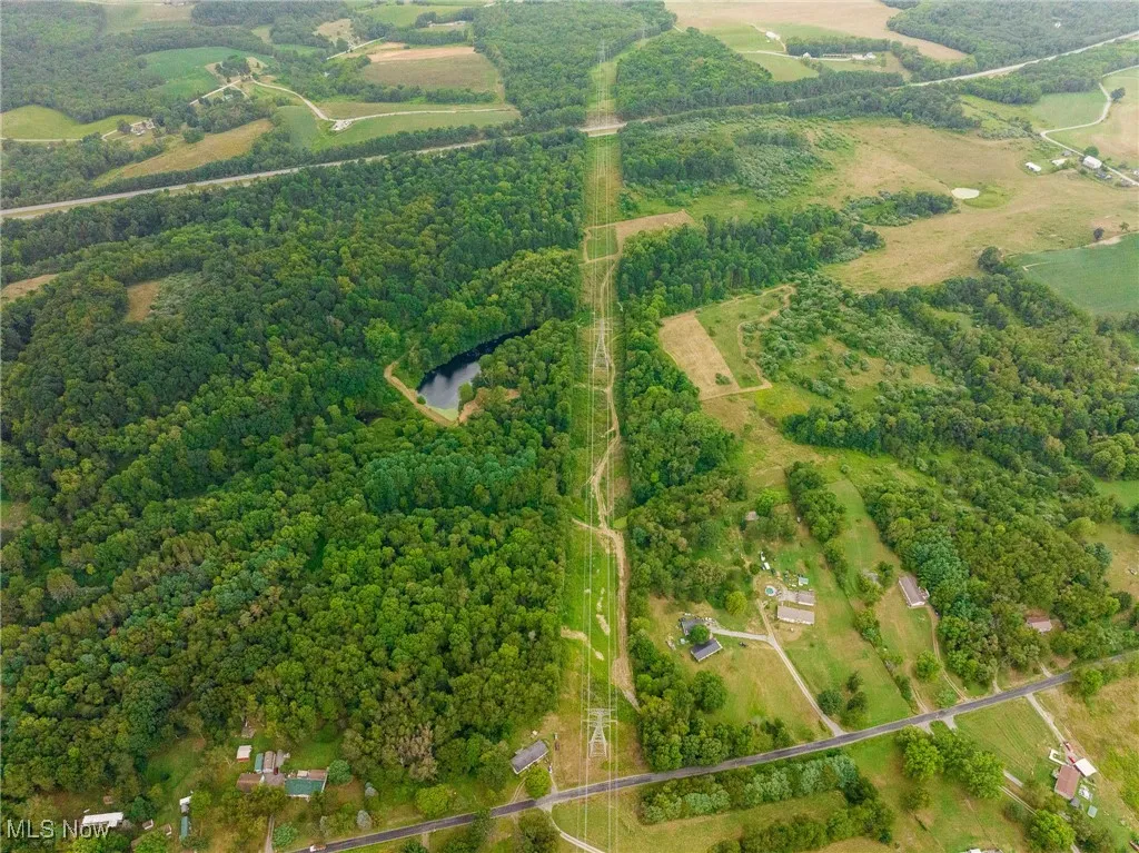 Aerial overview of property's location featuring rural landscape and a nearby body of water