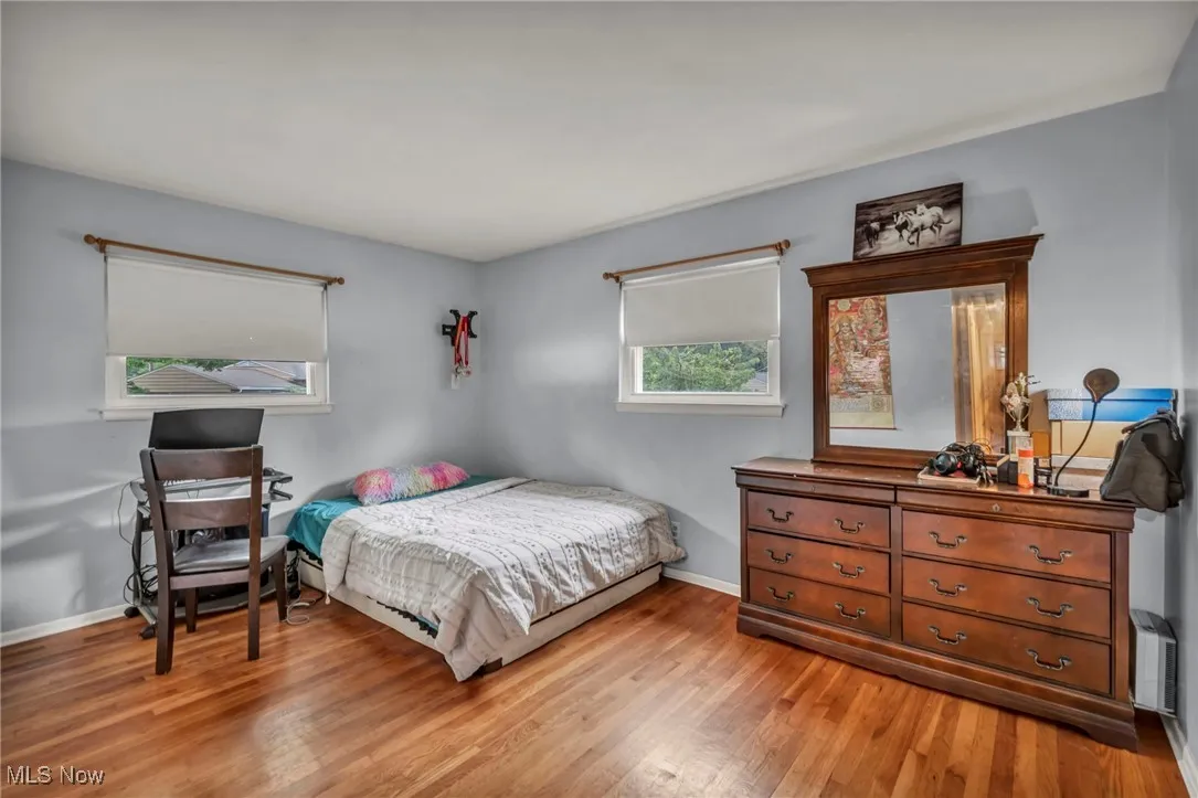 Bedroom featuring light wood-style floors and baseboards