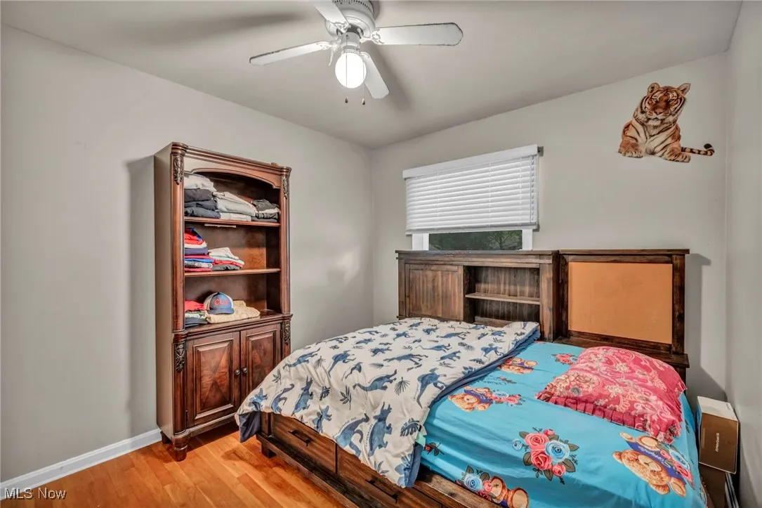 Bedroom featuring wood finished floors and a ceiling fan