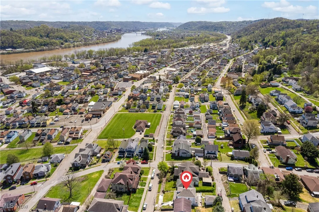 Aerial view of property's location featuring nearby suburban area and a large body of water