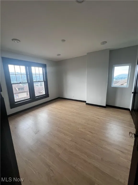 Spare room featuring light wood-type flooring and recessed lighting