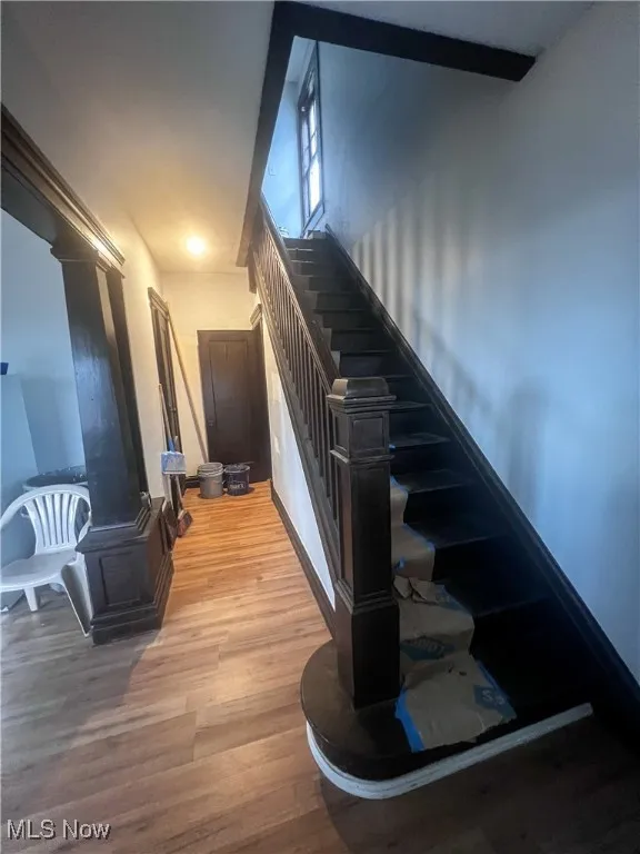 Stairs featuring wood finished floors