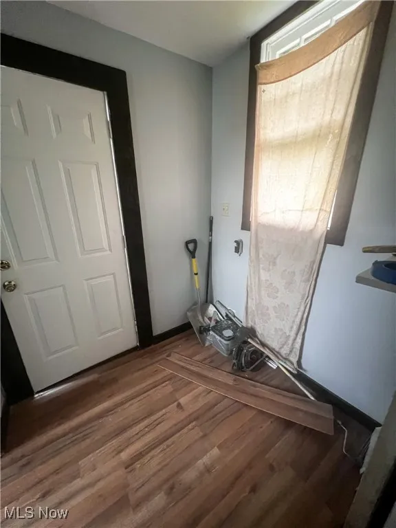 Entryway with wood finished floors and baseboards