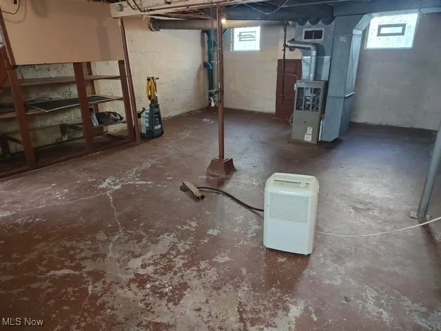 Basement featuring heating unit