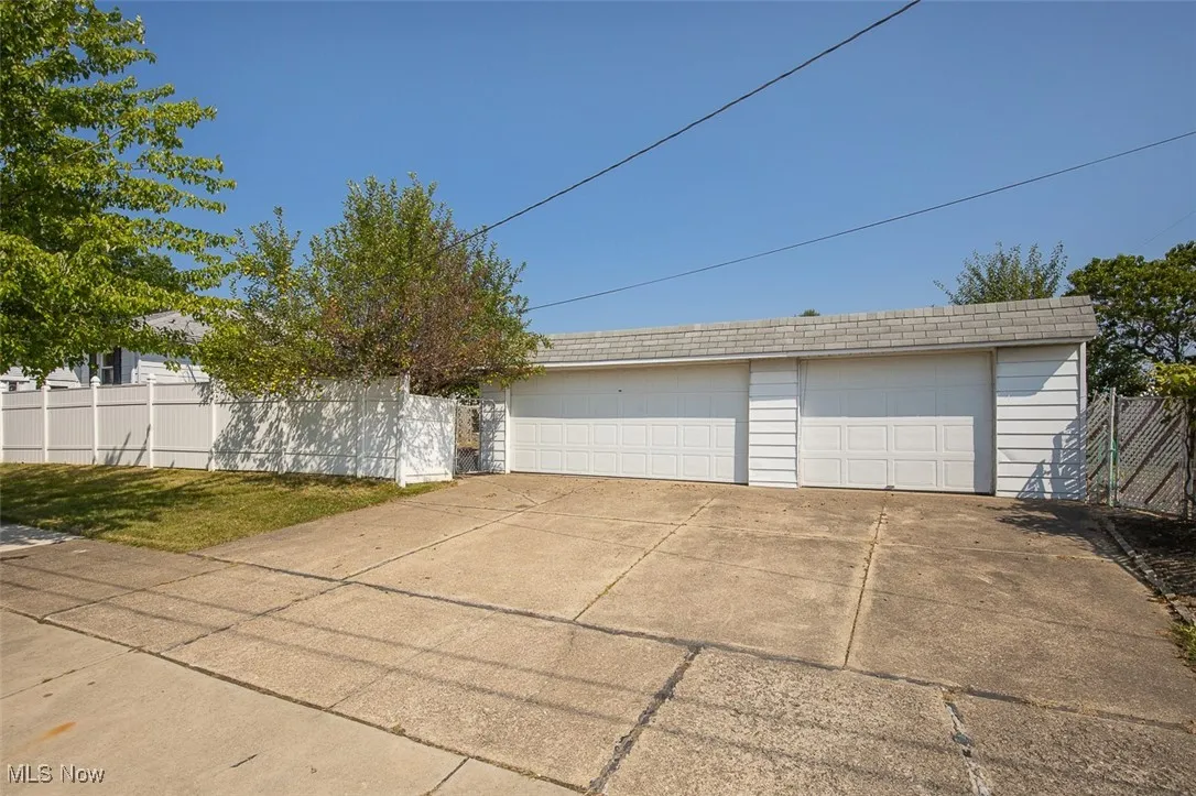3 car garage with side entrance near patio.