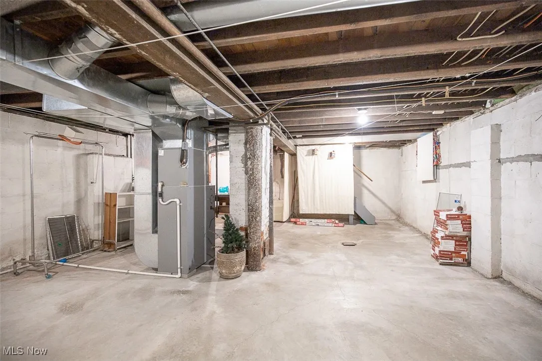 Unfinished basement with heating unit Main house