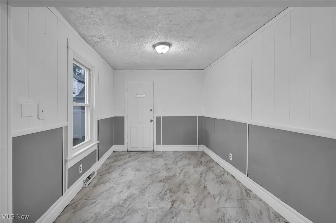 Unfurnished dining area featuring a textured ceiling