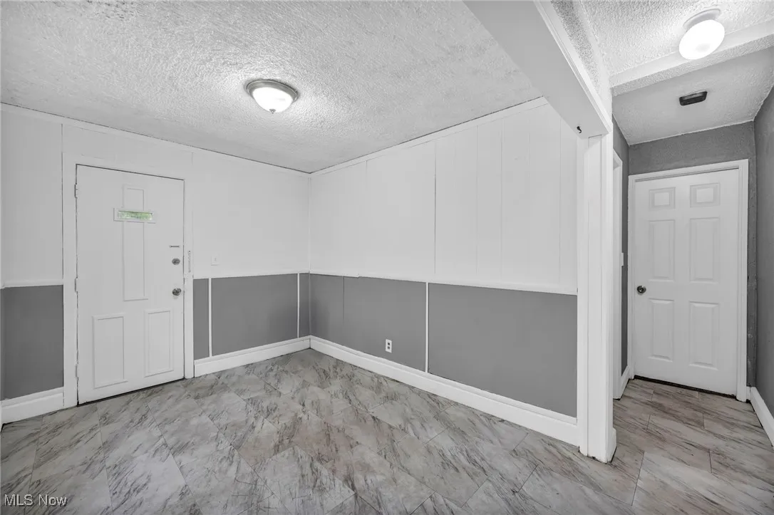 Empty room with a textured ceiling