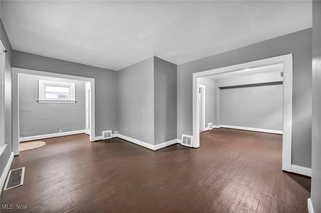 Bonus room featuring dark wood-style flooring
