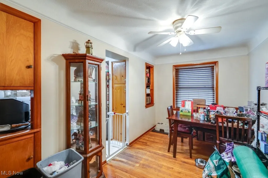 Dining room with light wood-type flooring and a ceiling fan