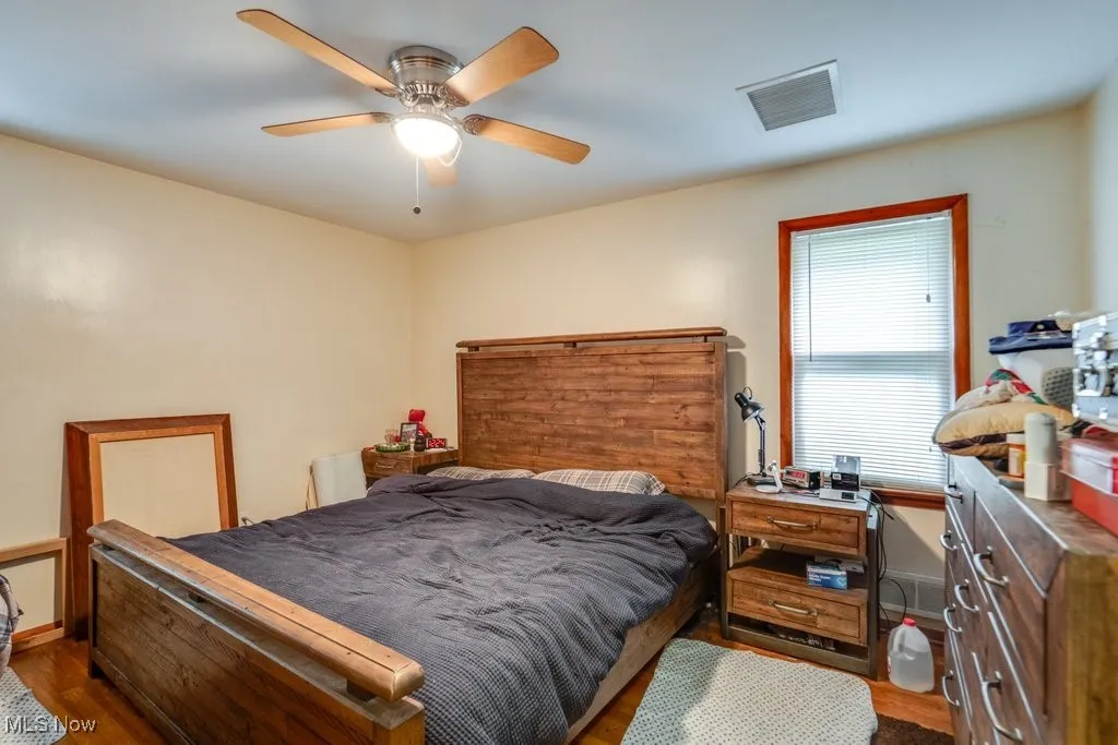 Bedroom featuring dark wood-style flooring and ceiling fan