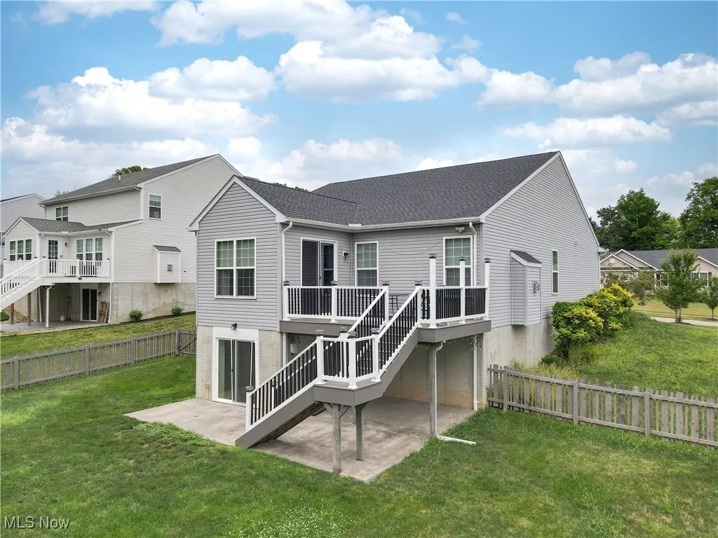 Back of house featuring a patio, deck and fenced yad