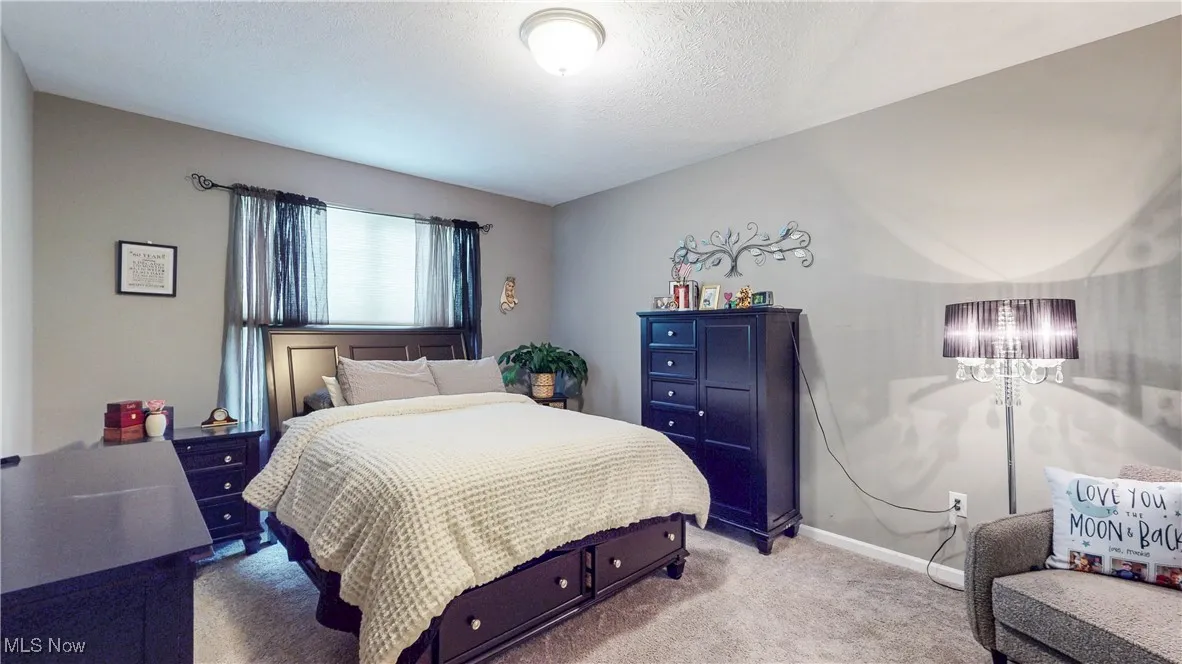 Bedroom with carpet and a textured ceiling
