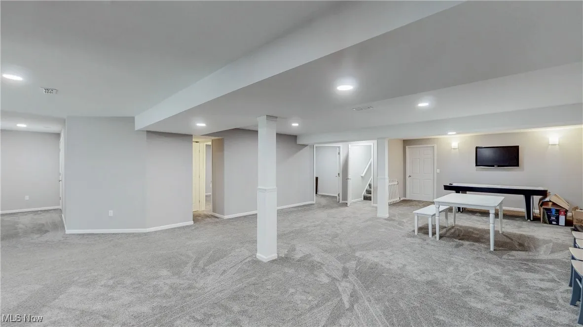 Finished Rec room with carpet, recessed lighting, and stairs