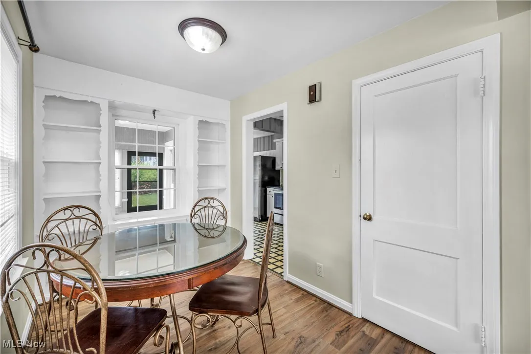 Dining room with wood finished floors and built in features