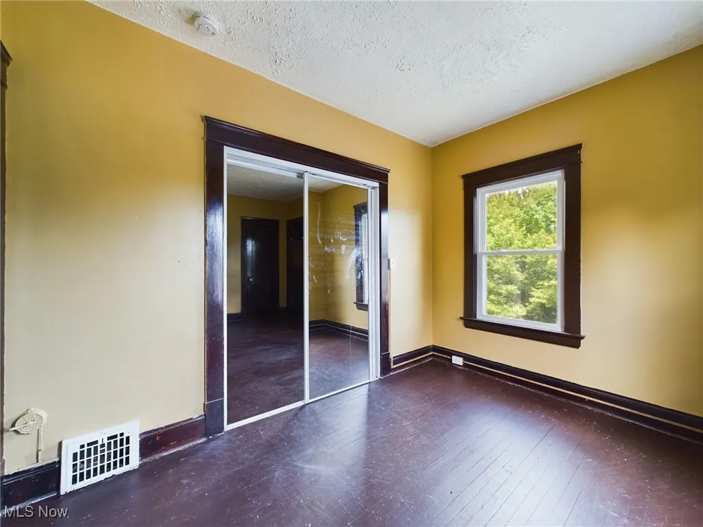 Unfurnished bedroom with a textured ceiling and baseboards