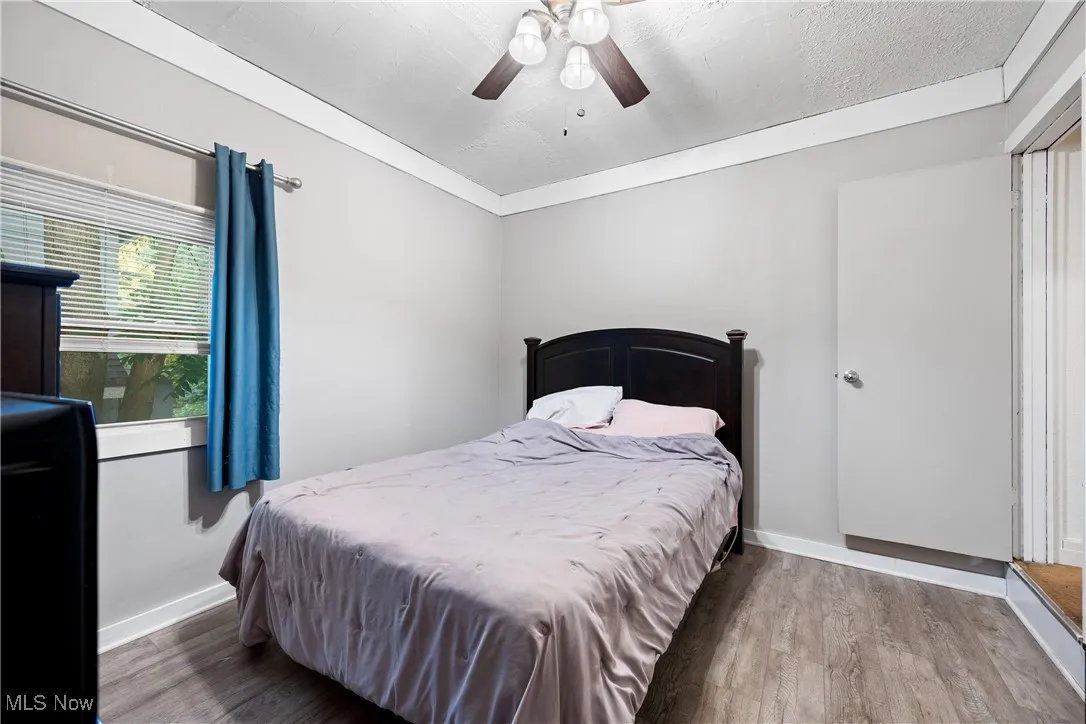 Bedroom with wood finished floors and ceiling fan