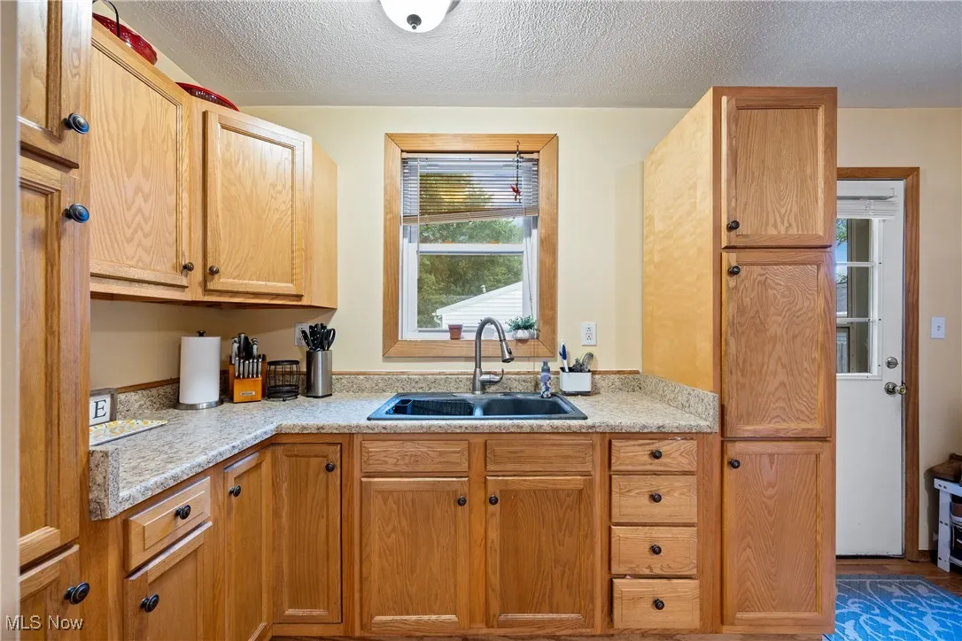 Kitchen featuring light countertops and a textured ceiling