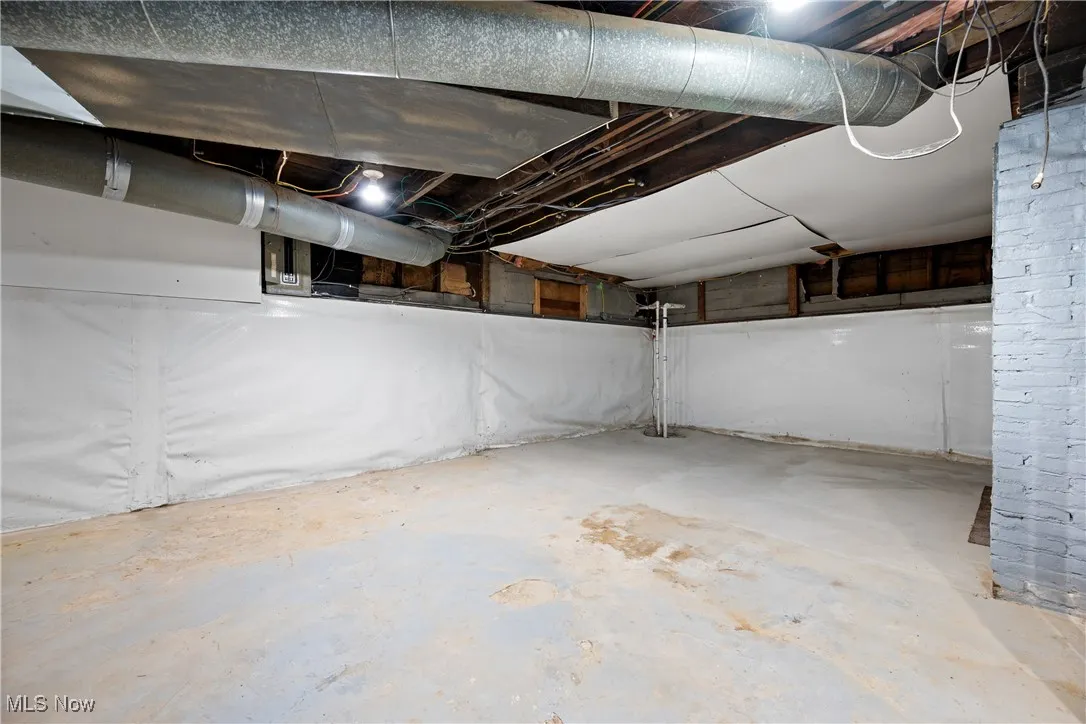 Unfinished below grade area featuring drainage system