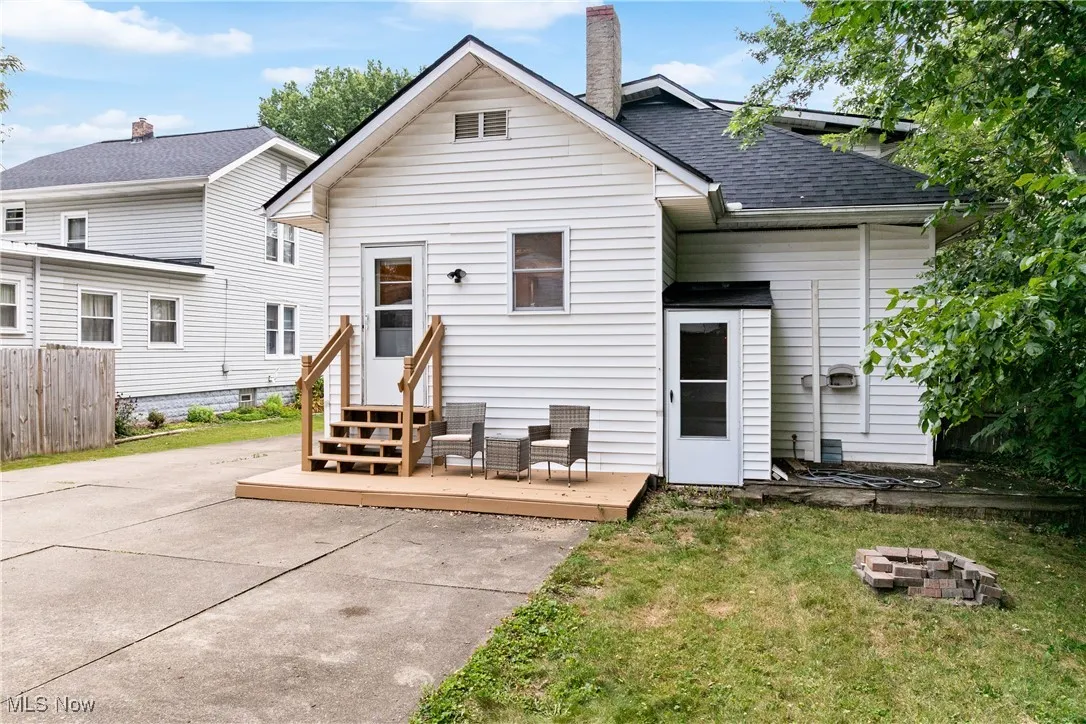 Rear view of property with a fire pit, a chimney, a deck, and a patio area