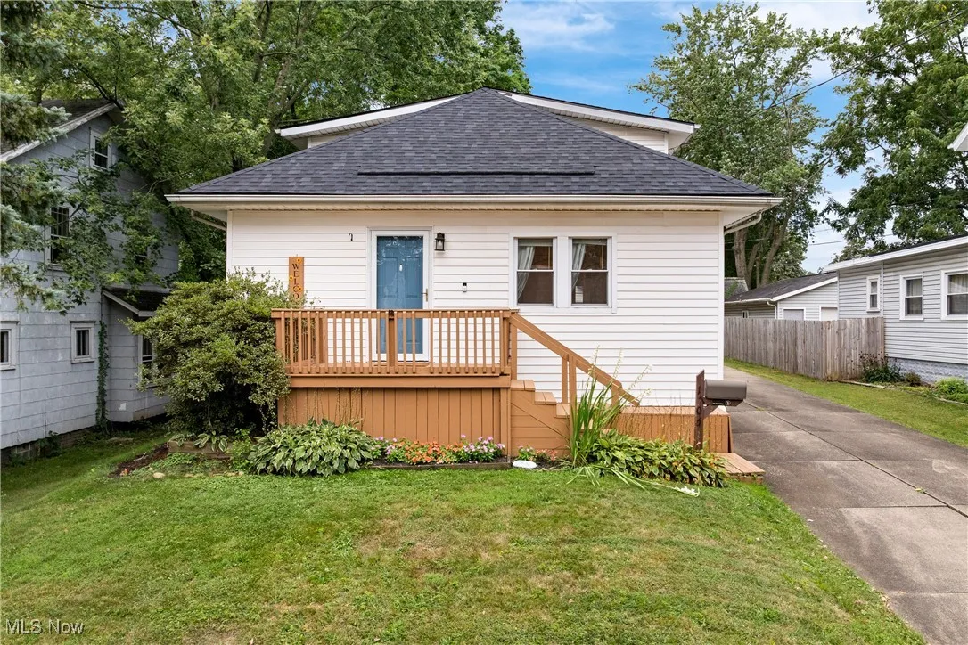 Bungalow-style home featuring a deck and a shingled roof
