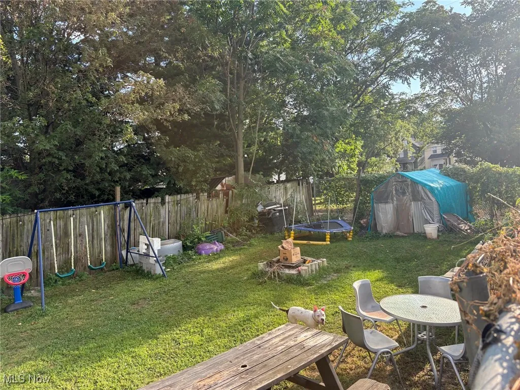 View of yard with view of scattered trees, and a storage shed