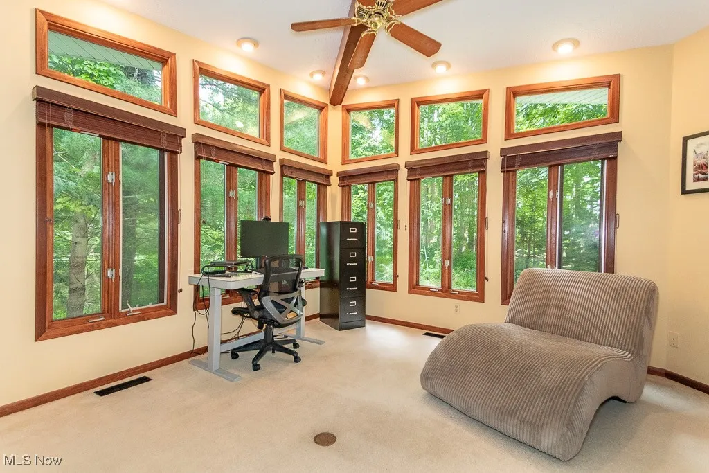 Carpeted office with a high ceiling, recessed lighting, and a ceiling fan