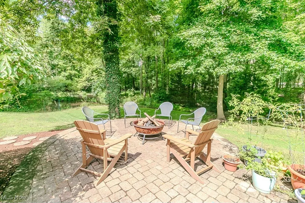View of patio with a fire pit