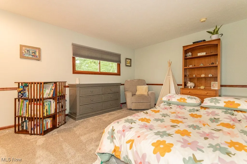 Bedroom featuring light carpet