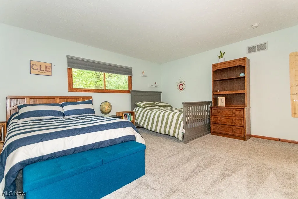 Bedroom with light carpet and baseboards