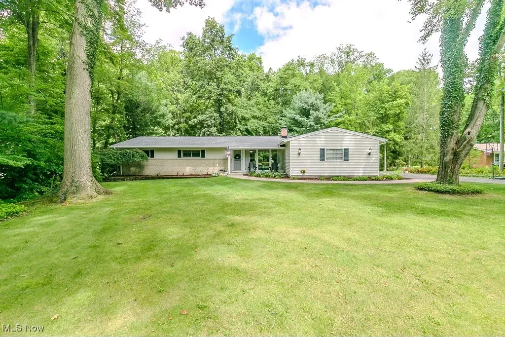 Single story home with a front lawn and a porch