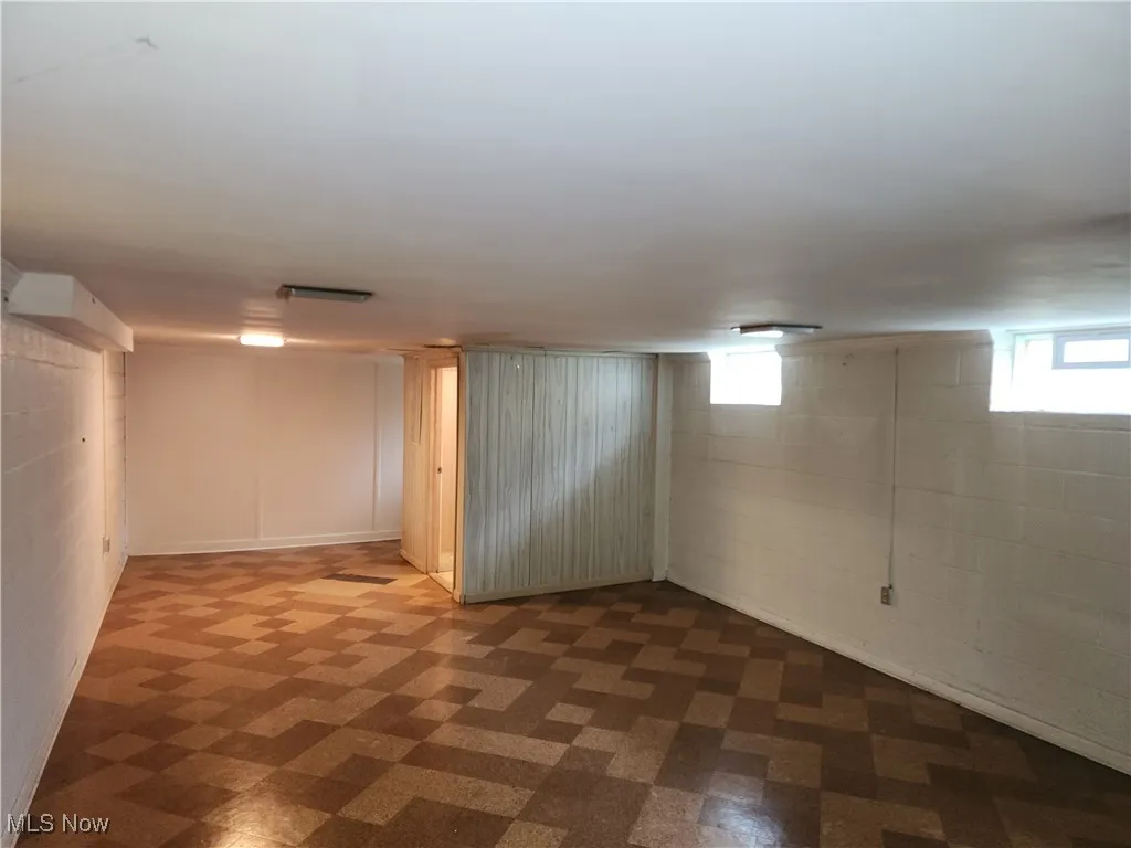 Below grade area featuring light flooring and plenty of natural light