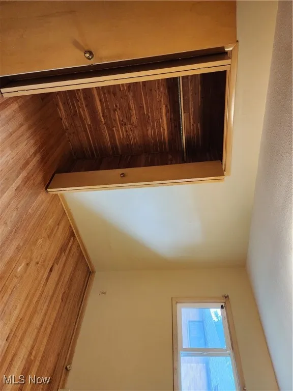Unfurnished bedroom featuring light wood-style floors, a closet, and a textured ceiling