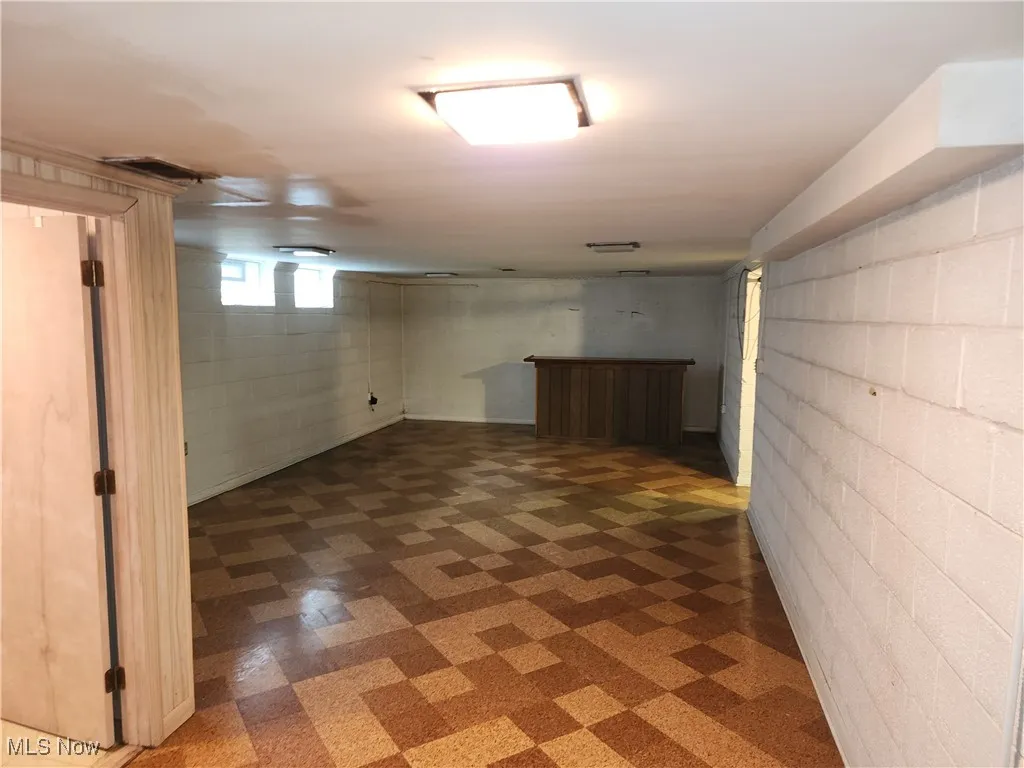 Below grade area featuring tile patterned floors and a dry bar
