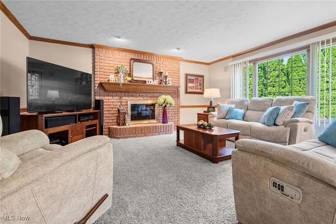 Family room with brick fireplace.