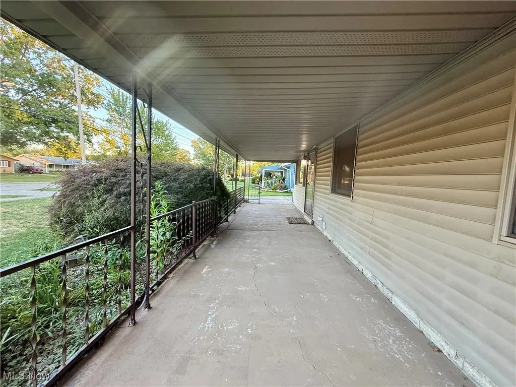 Porch featuring an attached carport