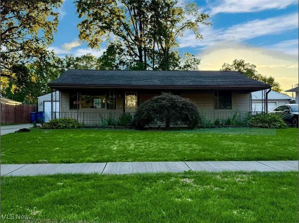 View of front of property with covered porch and roof with shingles