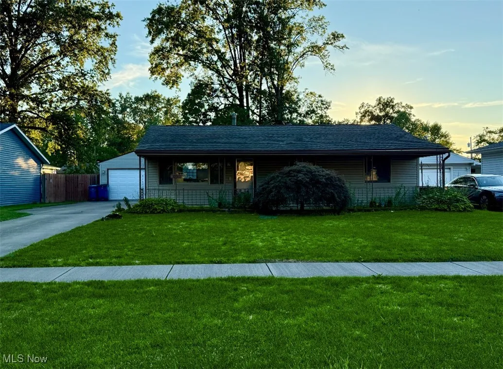 View of front facade featuring driveway and a porch