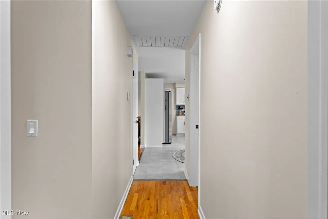 Hallway with light wood finished floors and baseboards