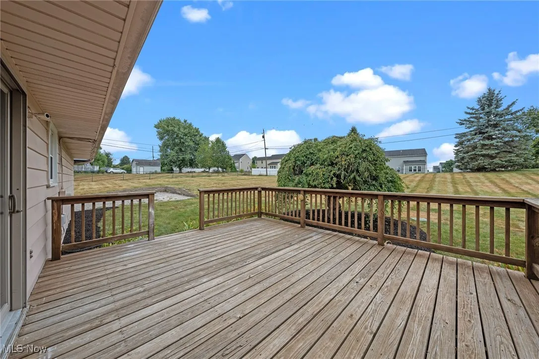 Wooden deck featuring a lawn