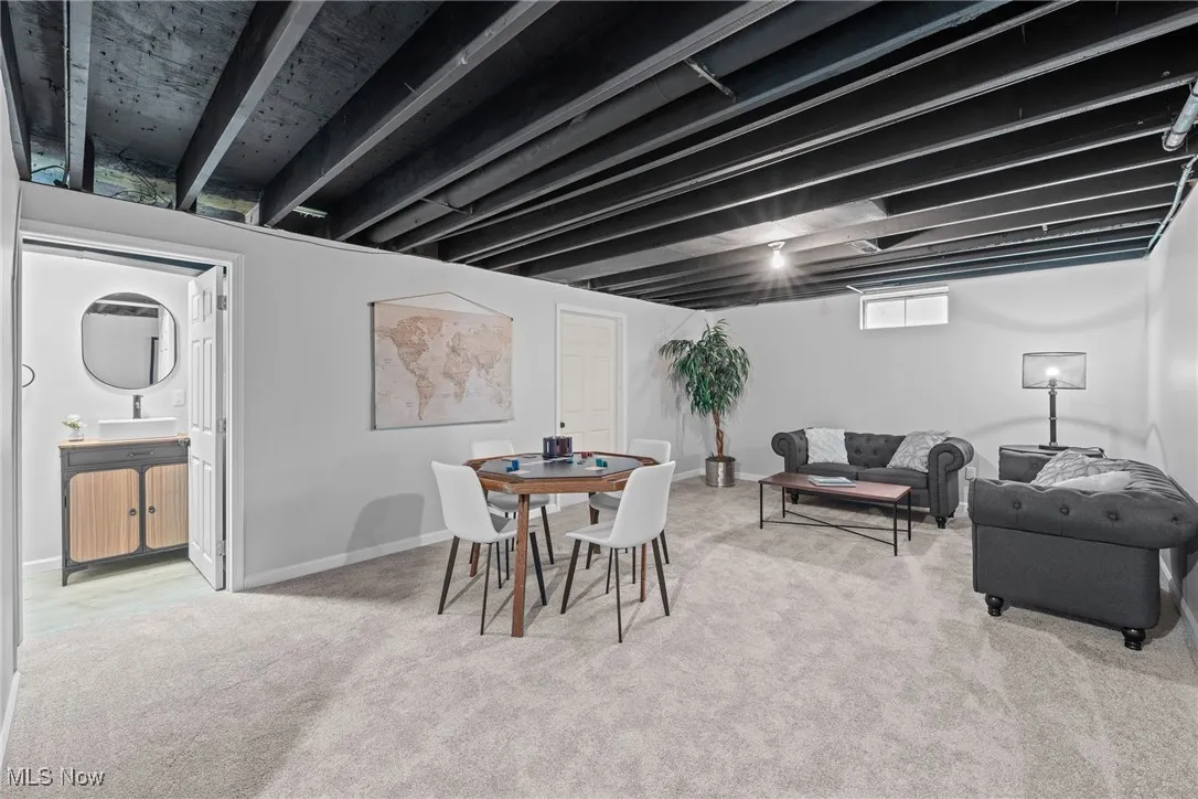 Dining space featuring light colored carpet and baseboards